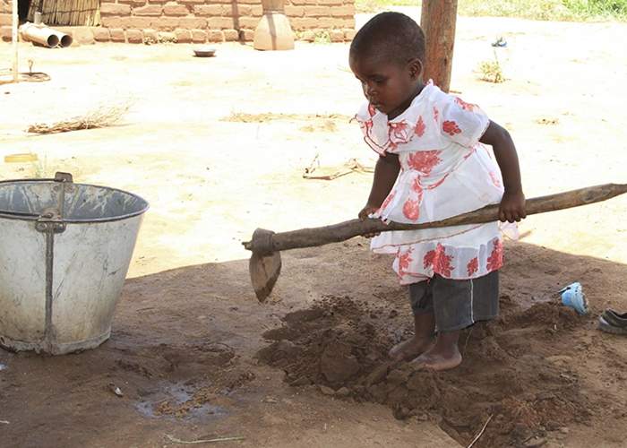 Osman and Tumasile's youngest daughter, practicing her farming techniques.