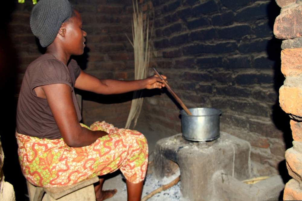 Stella cooking on a fixed stove made by the village stove group.